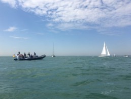 boats at sea with light clouds in the sky
